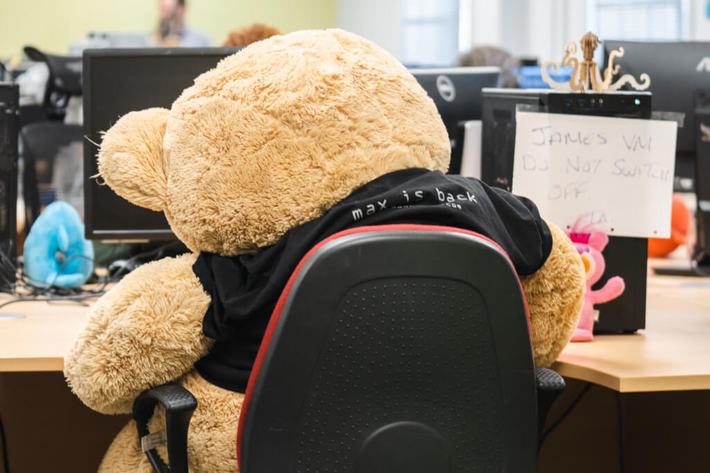 Photo of a giant teddy bear sitting at a desk